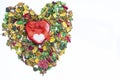 A red heart metal gift box on colorful dried flowers used as wallpaper Royalty Free Stock Photo