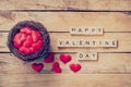 Red heart in nest with wooden text Happy Valentine Day on wood t Royalty Free Stock Photo