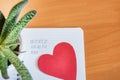 A red heart and a Notepad with the inscription WORLD NO TOBACCO DAY. The world day of refusal of Smoking, TOP VIEW