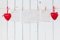 Red heart and old paper blank hanging at clothesline on wood white background with space. Valentine Day. Royalty Free Stock Photo