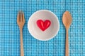 Red heart onwhite bowl ceramic with wooden fork and spoon Royalty Free Stock Photo