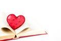 Red heart is in open pages of the book Royalty Free Stock Photo