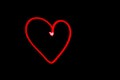 Red heart outline light painting in black night sky