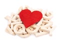 Red heart over the pile of wooden letters