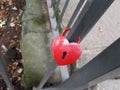 Red heart padlock locked on a rail isolated Royalty Free Stock Photo