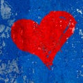 Red heart painted over grungy and old weathered dark blue wall texture background with painting peeling of Royalty Free Stock Photo