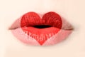 Red heart painted on woman lips close up Royalty Free Stock Photo