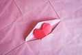 Red heart paper origami in pink envelope background
