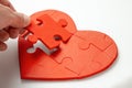 Red heart puzzle on white background. Concept second half of the heart in love for Valentine`s Day or illness Royalty Free Stock Photo