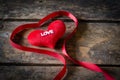 Red heart with ribbon on wooden background, Valentines Day bac