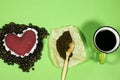 red heart with Roasted coffee beans and powder and cup on wood table, love coffee concept. Royalty Free Stock Photo