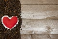 Red heart on Roasted coffee beans  on wood table, love coffee concept Royalty Free Stock Photo