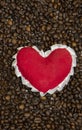 red heart on Roasted coffee beans on wood table, love coffee concept Royalty Free Stock Photo