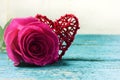 Red heart and roses on the wooden background.