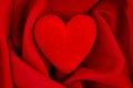 Red heart on red satin fabric background Royalty Free Stock Photo