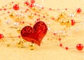 Red heart with beads on a gold background Royalty Free Stock Photo