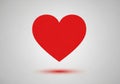 A red heart shape centered on a light gray background. The heart Royalty Free Stock Photo