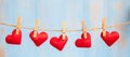 Red heart shape decoration hanging on line with copy space for text on blue wooden background. Love, Wedding, Romantic and Happy Royalty Free Stock Photo