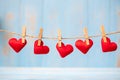Red heart shape decoration hanging on line with copy space for text on blue wooden background. Love, Wedding, Romantic and Happy Royalty Free Stock Photo