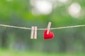 Red heart shape decoration hanging on line with copy space for text on green nature background. Love, Wedding Romantic and Happy Royalty Free Stock Photo