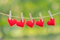Red heart shape decoration hanging on line with copy space for text on green nature background. Love, Wedding Romantic and Happy Royalty Free Stock Photo