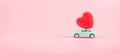 Red heart shape decoration on mini car toy with copy space for text on pink background. Love, Wedding, Romantic and Happy Royalty Free Stock Photo