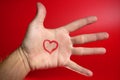 Red heart shape drawed on a male human hand Royalty Free Stock Photo