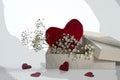 Red heart shape in a gift box with some small flowers, love symbol for valentines day or mothers day, retro style with