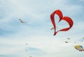 Red heart shape kite is flying in blue sky Royalty Free Stock Photo