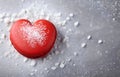 red heart shape macaron cookie on grey snowy background top view