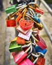 The red heart shape padlock hanging in the middle of many blurred love padlocks. Concept padlocks love forever. Valentine Royalty Free Stock Photo