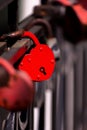 The red heart shape padlock hanging in the middle of many blurred padlocks. Royalty Free Stock Photo