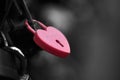 The red heart shape padlock hanging in the middle of many blurred padlocks Royalty Free Stock Photo