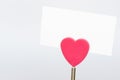 A red heart shape paper holder and a white paper Royalty Free Stock Photo