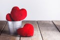 Red Heart Shape pillows in Metal bucket on wooden background Royalty Free Stock Photo