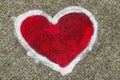 Red heart shape with white outline painted sprayed on massive concrete wall. Royalty Free Stock Photo