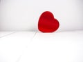 Red heart shape on white wooden