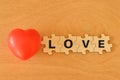 Red heart shape and wooden jigsaw puzzle with text LOVE Royalty Free Stock Photo