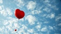 Red Heart-Shaped Balloon Soaring in the Blue Sky - Valentine's day concept Royalty Free Stock Photo