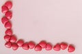 Red heart-shaped beads are located in the lower left corner on a pink background, mock-up for design Royalty Free Stock Photo