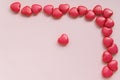Red heart-shaped beads are located in the upper right corner on a pink background, mock-up for design Royalty Free Stock Photo