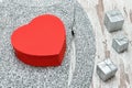 Red heart shaped box on a knitted sweater. Silver gift boxes. Fa Royalty Free Stock Photo