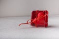 Red heart-shaped candle in box on white background. Small Valentines day present, symbol or souvenir. Copy space