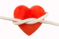 Red heart-shaped candle and a rope