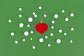 Red heart shaped Christmas tree bauble surrounded by snowballs Royalty Free Stock Photo