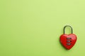 Red heart shaped combination lock on green background, top view. Space for text Royalty Free Stock Photo