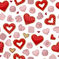 Red heart shaped cookies and pink chocolate candies isolated on white background. Royalty Free Stock Photo