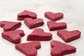 Red heart-shaped cookies on a white table closeup, baking for Valentine's Day