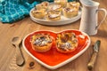 Red heart-shaped dish with pastries for Valentine`s Day.