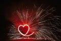 Red heart shaped firework with sparkles on black background in n Royalty Free Stock Photo